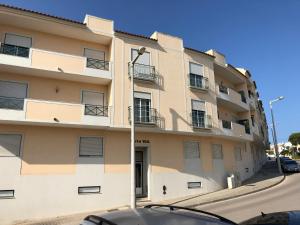 a tall building with cars parked in front of it at Montenegro Dreams in Faro