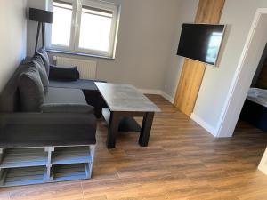 a living room with a couch and a table at Domek Maris in Międzyzdroje