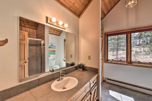 a bathroom with a sink and a mirror at Quiet Guffey Getaway with Private Deck, Pond and Canoe in Guffey +26 photos