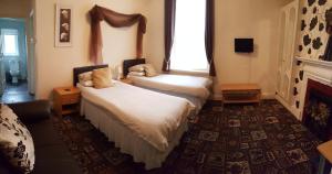 Postel nebo postele na pokoji v ubytování Norwyn Court Holiday Apartments