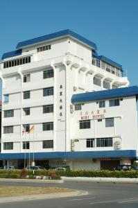 a white building with chinese writing on it at Miri Hotel in Miri