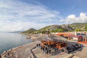 a restaurant on the shore of a body of water at Campsite Eurokamp Raca in Sveti Juraj