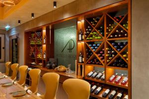 a restaurant with a long table with chairs and wine bottles at AP Eva Senses in Faro