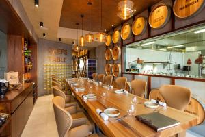 a long dining room with a long table and chairs at AP Eva Senses in Faro