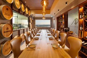 a long table in a wine tasting room with chairs at AP Eva Senses in Faro