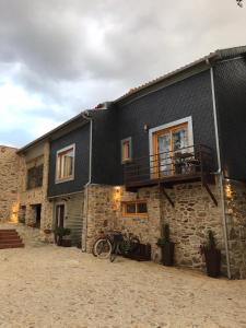 a building with motorcycles parked in front of it at Casa da Mó - Douro in Armamar