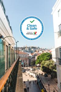 a sign that reads green and safe above a city street at Rossio Boutique Hotel in Lisbon