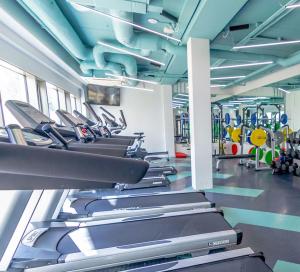 a gym with a row of treadmills at Heyday Student Accommodation in Dublin