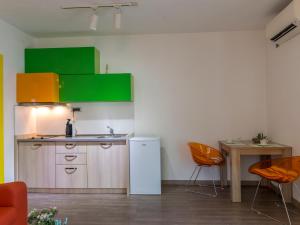 a kitchen with a white refrigerator and a table at Apartments Windrose in Kotor