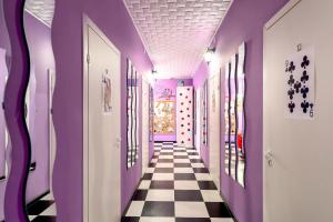a hallway with purple walls and a checkered floor at WonderHostel Central in Saint Petersburg