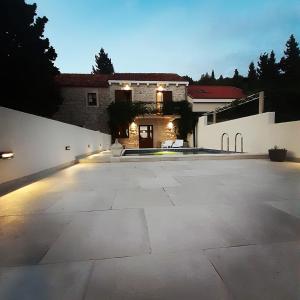 a large driveway with a house in the background at Villa Dragi in Klek