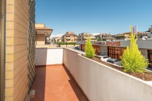 a balcony of a building with trees and buildings at Fiumicino Dream & Fly in Fiumicino