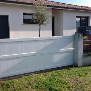 una cerca frente a una casa con un árbol en VILLA 800 MÈTRES DE LA PLAGE, en Andernos-les-Bains