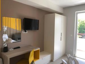 a living room with a tv on the wall at Apartments Kanevce City Center in Ohrid