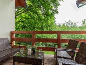 a patio with two chairs and a table on a deck at VacationClub - Myśliwska 60 Apartament 1 in Karpacz