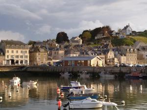 a group of boats are docked in a harbor at Fishermen's Friend in Port-en-Bessin-Huppain