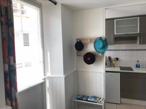 a small kitchen with a sink and a window at Fishermen's Friend in Port-en-Bessin-Huppain