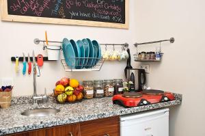 a kitchen counter with a bowl of fruit and a sink at Cumbalı 27 in Istanbul