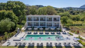 an aerial view of a large white building with a swimming pool at La Maison Corfu - Adults Only in Ýpsos