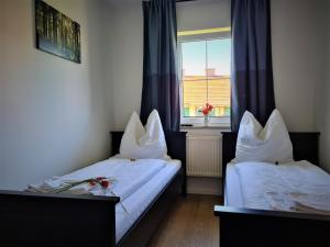 Een bed of bedden in een kamer bij Gästehaus Kirmerschneiderhof bei Erding