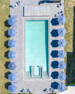 an overhead view of a swimming pool with blue tiles at La Maison Corfu - Adults Only in Ýpsos