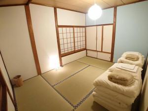 an empty room with two beds in a room at KINOSAKI KNOT - Vacation STAY 83610 in Toyooka