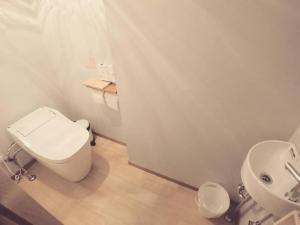 a bathroom with a white toilet and a sink at KINOSAKI KNOT - Vacation STAY 83611 in Toyooka