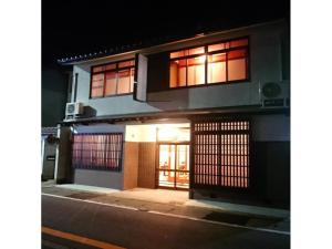a building with an open door at night at KINOSAKI KNOT - Vacation STAY 83611 in Toyooka