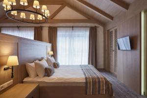a bedroom with a large bed and a window at AmstelSki in Bukovel