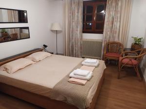 a bedroom with a bed with two towels on it at Cavo Paradiso Villa in Asprovalta