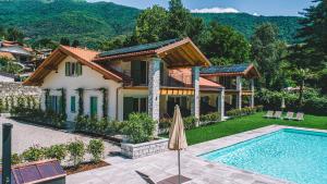 a villa with a swimming pool and a house at House & Pool in Mergozzo