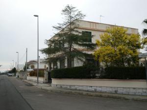 a building on the side of a street with trees at Terra di Fuori in Patù