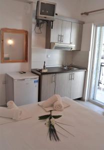 a kitchen with a table with towels and a sink at Sea La Vie - Studios Maria in Limenaria