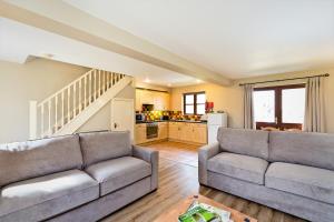 a living room with two couches and a kitchen at Knockerdown Cottages in Ashbourne +220 photos