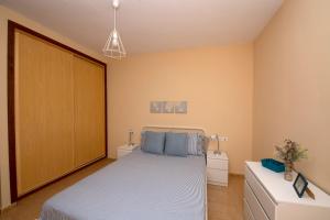 a bedroom with a bed and two night stands at Miramar 1 in San Sebastián de la Gomera