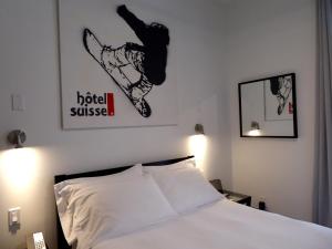 Postel nebo postele na pokoji v ubytování Swiss Hotel