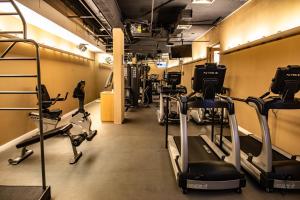 a gym with several treadmills and exercise bikes at The Singular Santiago in Santiago