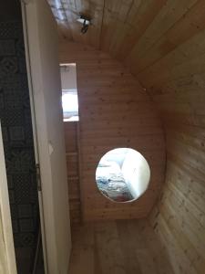 a round window in a wooden room with a wooden floor at les insolites du villaret in Saint-Vincent-les-Forts +21 photos