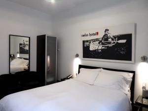 Postel nebo postele na pokoji v ubytování Swiss Hotel