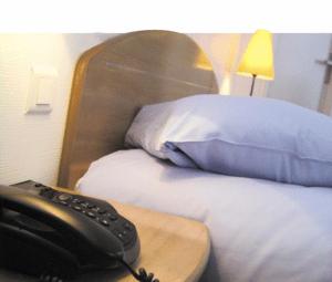 Postel nebo postele na pokoji v ubytování Amadeus Hotel