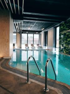 una gran piscina en un hotel con dos grifos en BALT Marynarska 8, en Sarbinowo