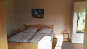 a bedroom with a bed with two pillows at Gartenblick in Lütow