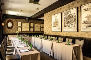 a row of tables in a restaurant with white tablecloths at The Singular Santiago in Santiago