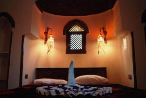 A bed or beds in a room at Nubian Eco Village