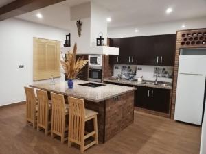 a kitchen with a large island with a counter top at La Belleza de Rodalquilar in Rodalquilar