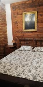 a bedroom with a bed and a painting on the wall at Dom Dziadka in Janów Podlaski