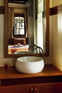 a bathroom with a large white sink and a mirror at Dewshore Resort in Ban Tai