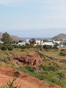 a small town in the middle of a dirt field at La Belleza de Rodalquilar in Rodalquilar