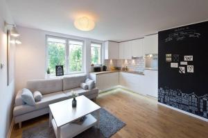 a living room with a couch and a kitchen at Cosy Old Town Gdansk in Gdańsk