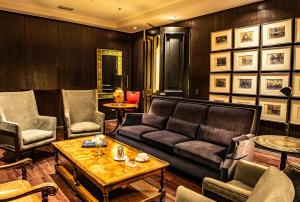 a living room filled with furniture and a coffee table at The Singular Santiago in Santiago